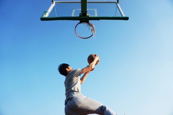 athlete dunking a basketball into the hoop