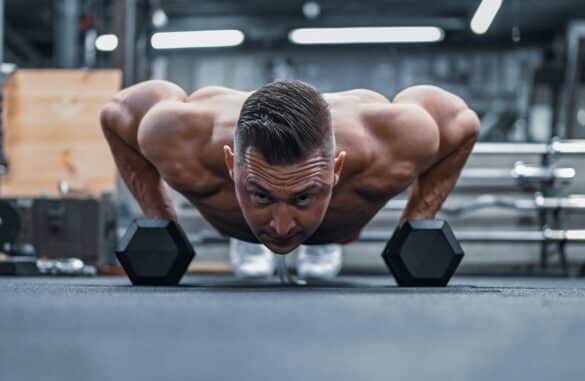 muscular man doing pushups in the gym